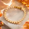 A golden oval-shaped bracelet set with light-colored gemstones, a fashionable and elegant women's jewelry accessory, is presented as a gift Specification image